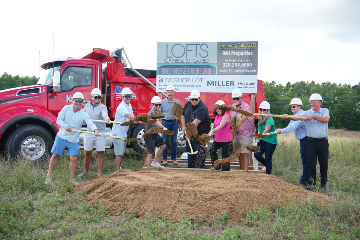 a group of 11 people shoveling dirt for a ground breaking in Pequot Lakes, MN